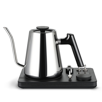 Stainless steel kettle with black base on a white background