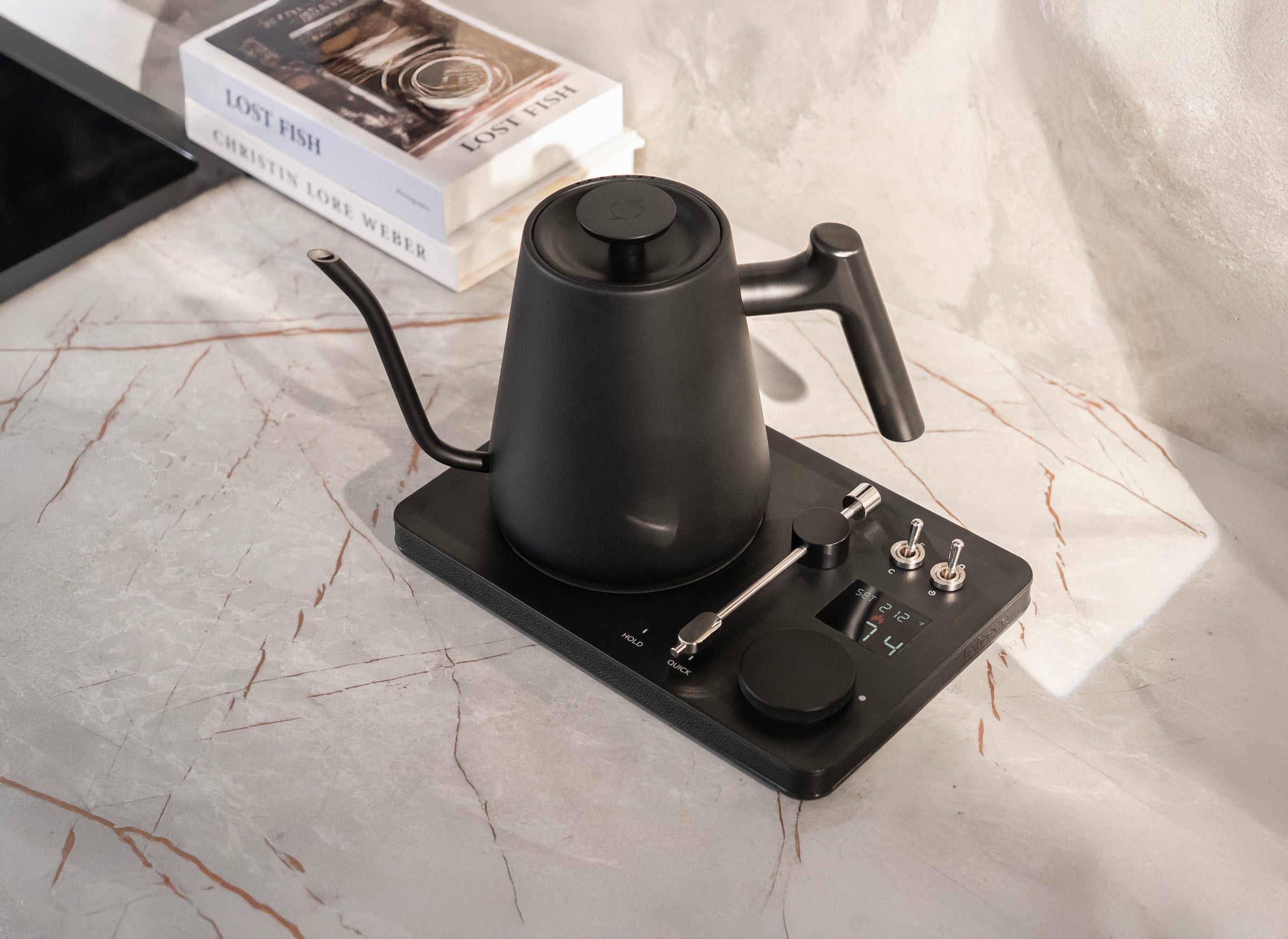 Lafeeca DJ Pour Over Black kettle on a digital scale with books in the background